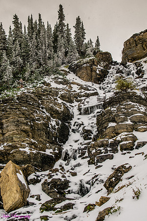Snowy waterfall at Logan Pass